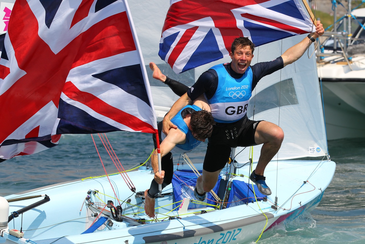 Luke Patience and Stu Bithell dive off their 470 after winning a silver medal